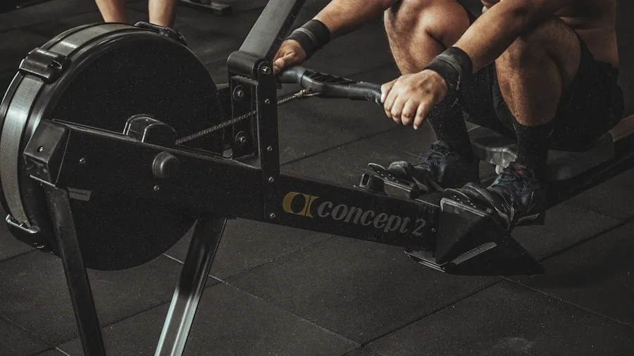 Person performing dynamic rowing exercise with focused intensity during indoor fitness training session