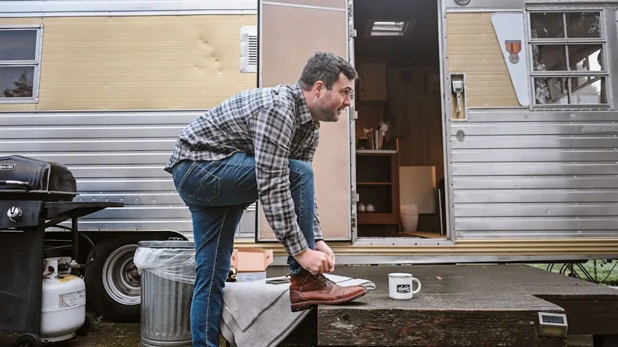 Person performing maintenance and cleaning on an outdoor grill in a backyard setting