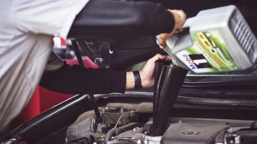 The %product_count% Best Oil Filters 3 Person performing routine vehicle oil filter maintenance in a home garage setting