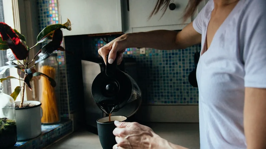 The %product_count% Best Electric Kettles 2 Person pouring hot water from kettle into mug in bright kitchen during morning coffee preparation