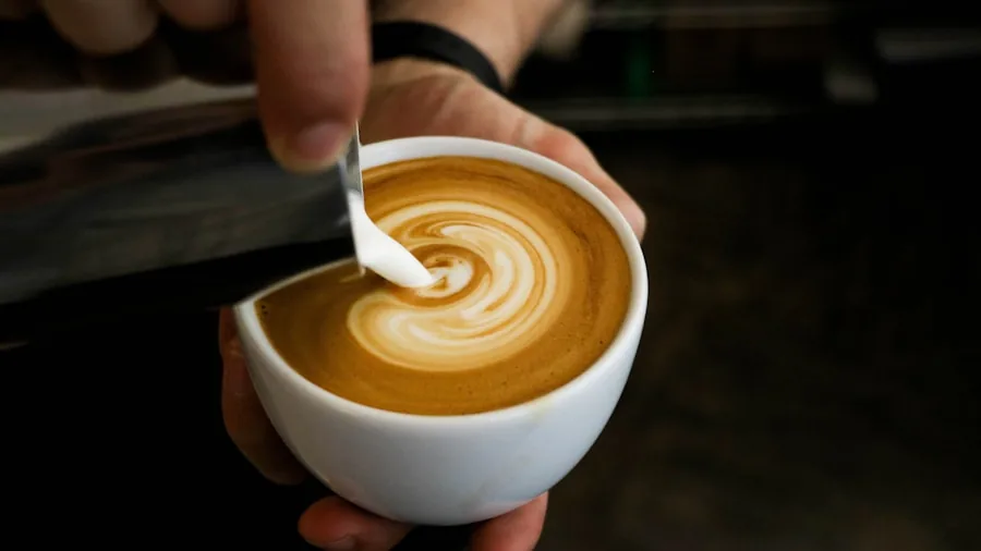 The %product_count% Best Single Serve Coffee Makers 6 Person pouring steamed milk into coffee cup to create latte art and foam
