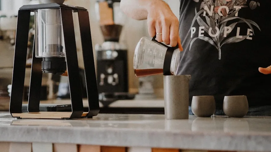 Person preparing coffee with precision grinder in modern kitchen during morning routine