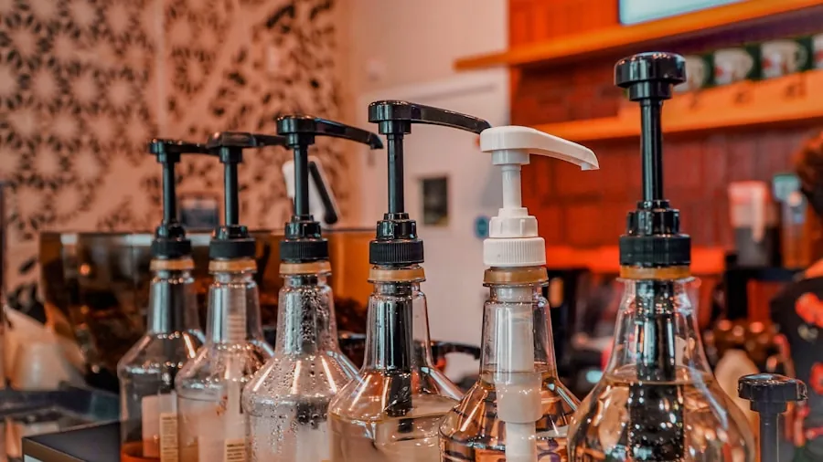 Person preparing coffee with syrup pump dispenser in home kitchen