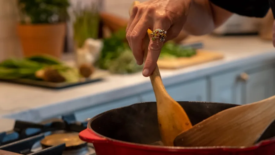 Person preparing fresh food in a modern kitchen with various ingredients on counter