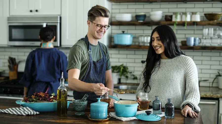 Person preparing multiple dishes in a contemporary kitchen with various cooking methods and ingredients