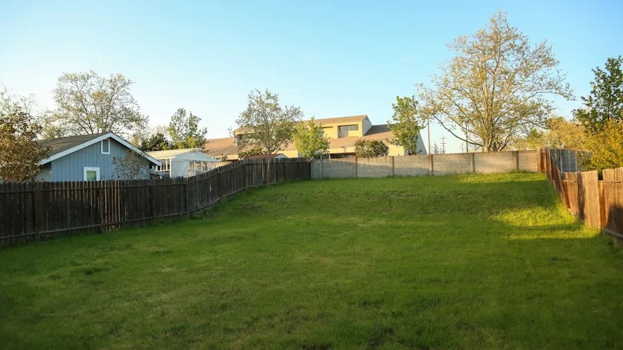 Person relaxing in backyard during evening with calm residential setting