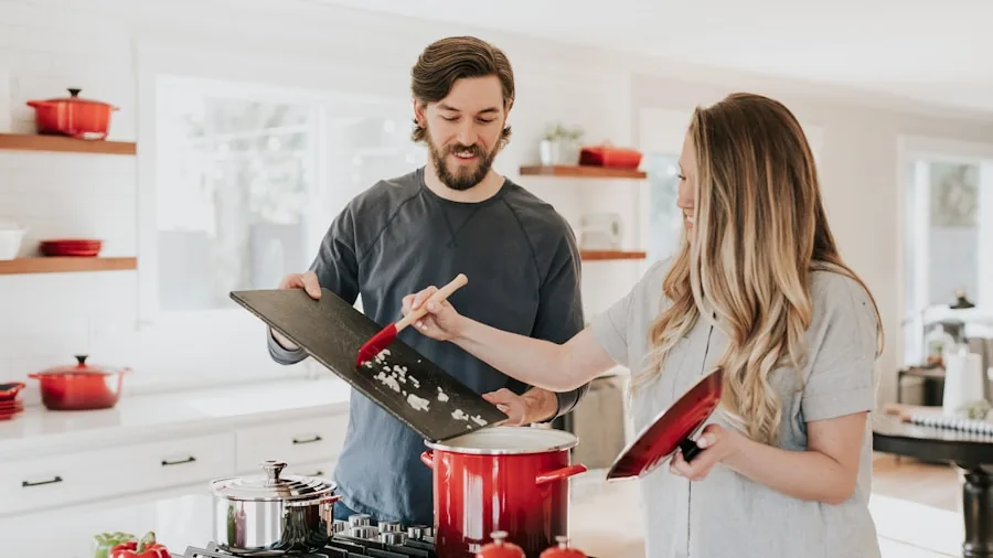Person researching and comparing appliance costs on laptop in modern kitchen