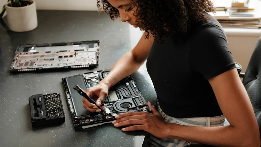Person reviewing computer motherboard specifications and case compatibility details at desk