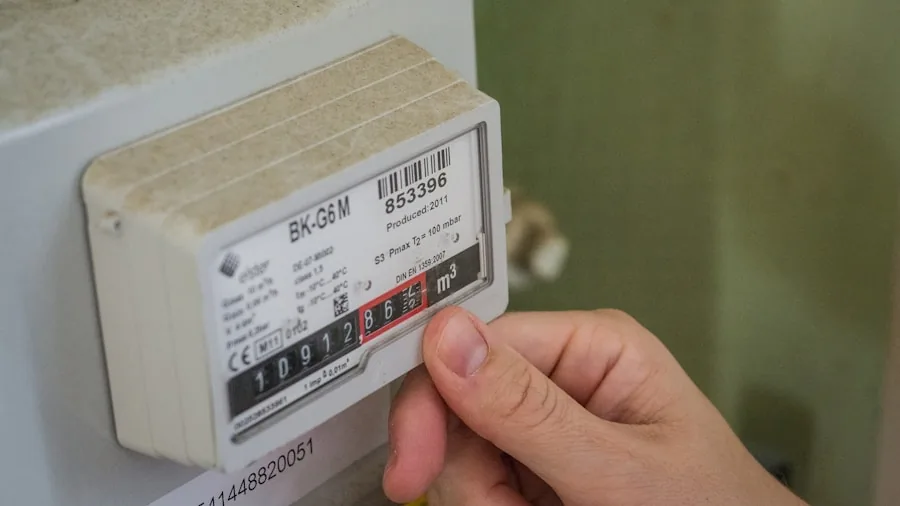 Person reviewing energy efficiency document at home desk with calculator and paperwork