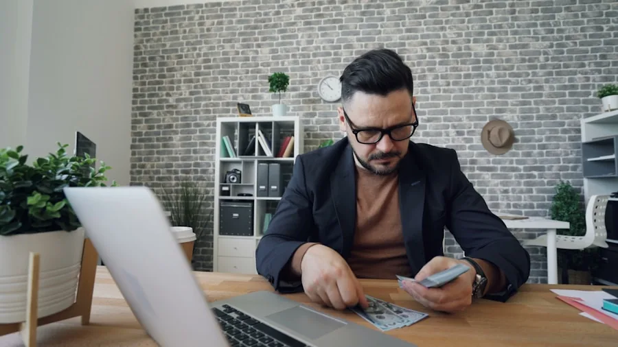 Person reviewing financial documents and budget planning at desk with calculator and notebook