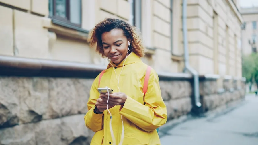 The %product_count% Best Workout Earbuds 6 Person reviewing fitness app on smartphone during outdoor workout session