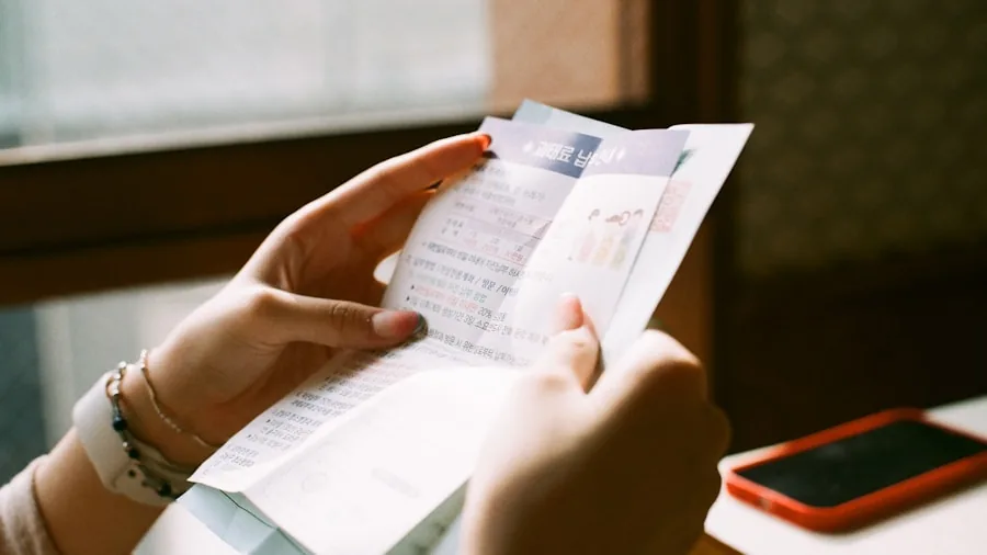 Person reviewing monthly utility bill at home, representing energy savings from efficient appliances