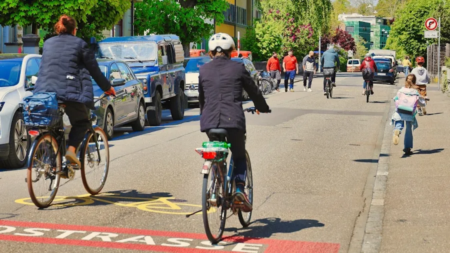 Person riding hybrid bike on paved trail through city neighborhood