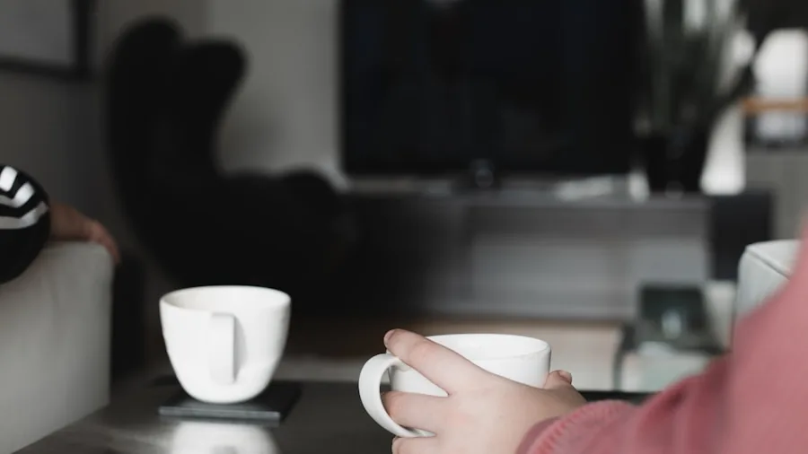 Person savoring a freshly made cappuccino with latte art in a cozy kitchen setting
