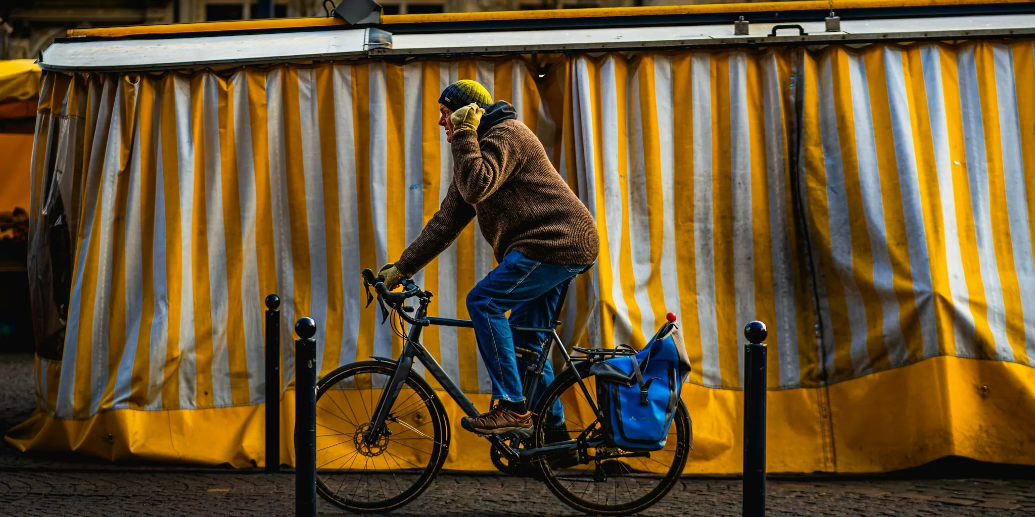 Person securing bicycle with lock on city street, protecting bike from theft