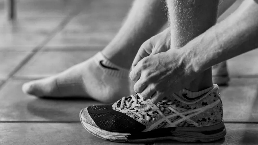 Person sitting down trying on workout shoes to test fit and comfort before purchasing