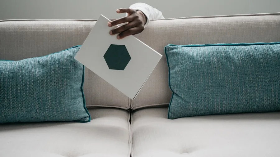 The 12 Best Sofas 3 Person sitting on sofa testing cushion comfort and support with hands