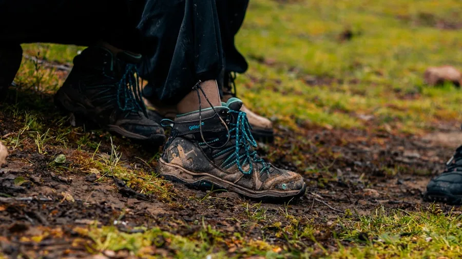 Person sitting on trail checking hiking boot fit with socks before trekking