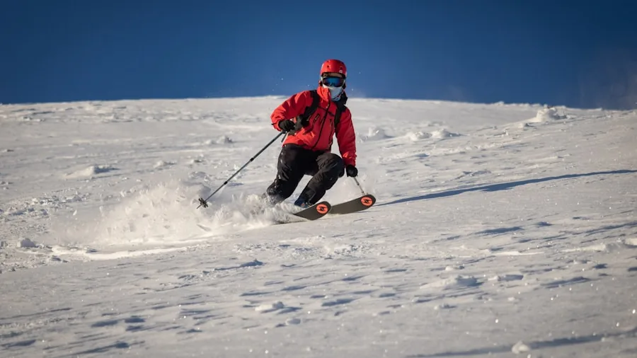 Person skiing downhill wearing a protective helmet on a snow-covered mountain slope