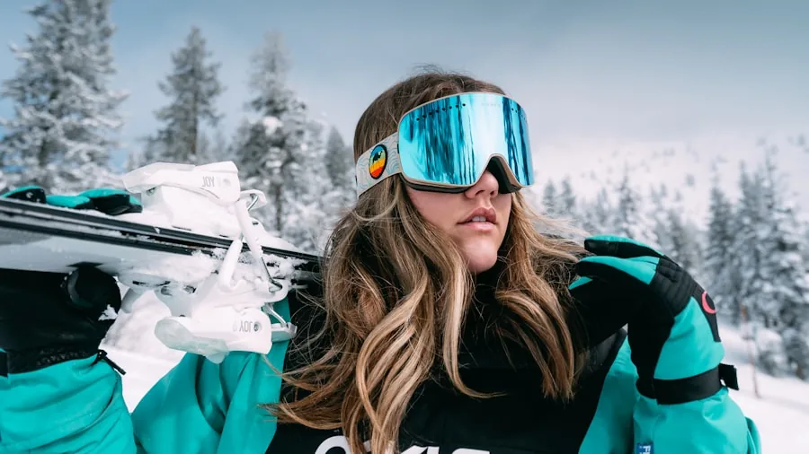 Person skiing downhill wearing prescription glasses and snow goggles on snowy mountain slope