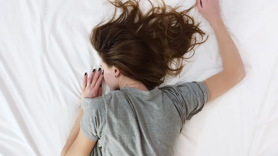 Person sleeping comfortably in bed with clean white linens, representing allergen-free sleep comfort