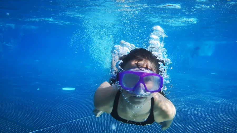 The %product_count% Best Open Ear Earbuds 6 Person swimming underwater in pool during active workout session