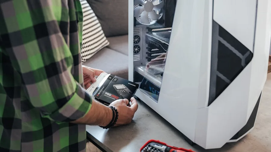 Person thoughtfully considering computer hardware upgrade decisions at desk