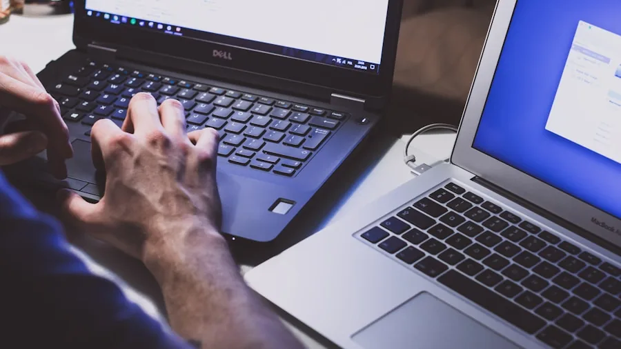 Person thoughtfully reviewing laptop choices and pricing options at desk