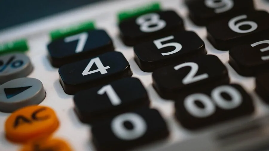 Person thoughtfully selecting tools while comparing options and budgets for a home project