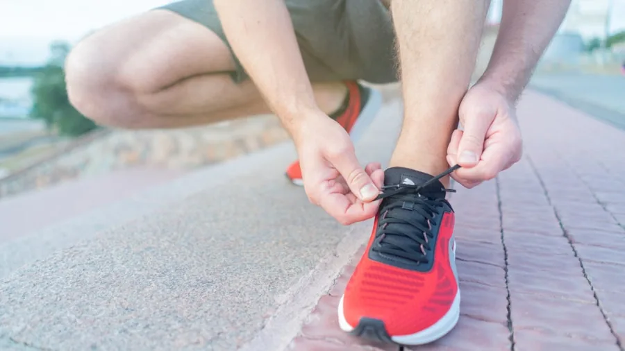 Person trying on athletic volleyball shoes while sitting, checking fit and sizing for proper footwear selection