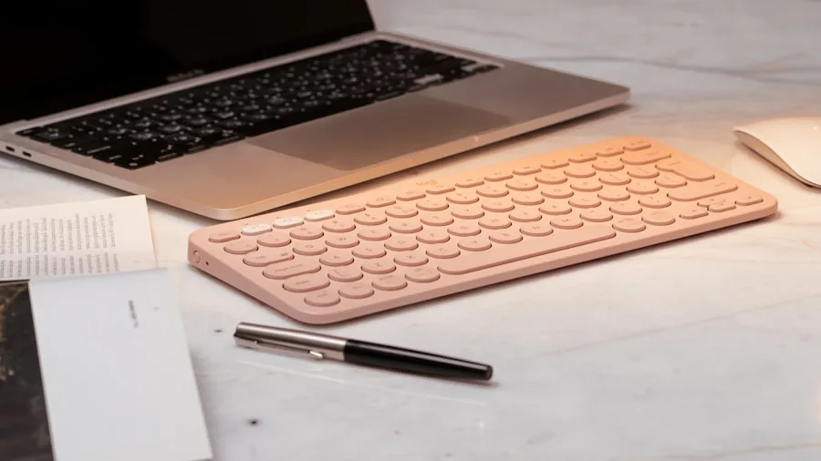 person typing on small keyboard compact workspace