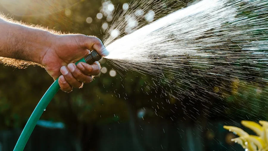 The %product_count% Best Garden Hoses 3 Person using garden hose to water plants in residential backyard setting