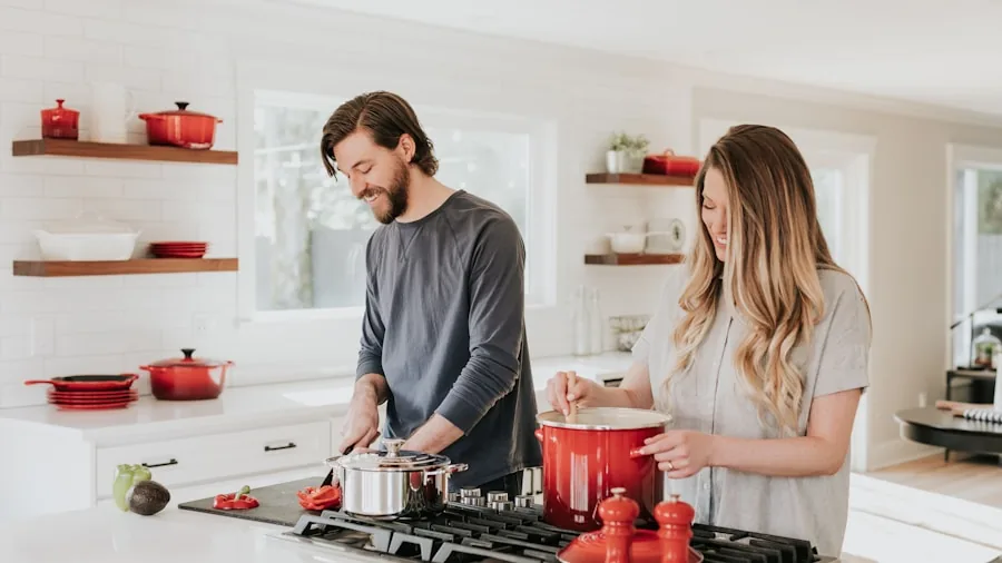 Person using portable cooktop at vacation rental kitchen with natural light and comfortable home setting