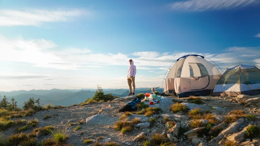 Person using portable power station to charge multiple devices while camping outdoors