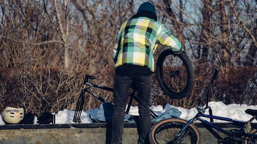 Person using portable tire inflator to pump up bicycle tire on outdoor path