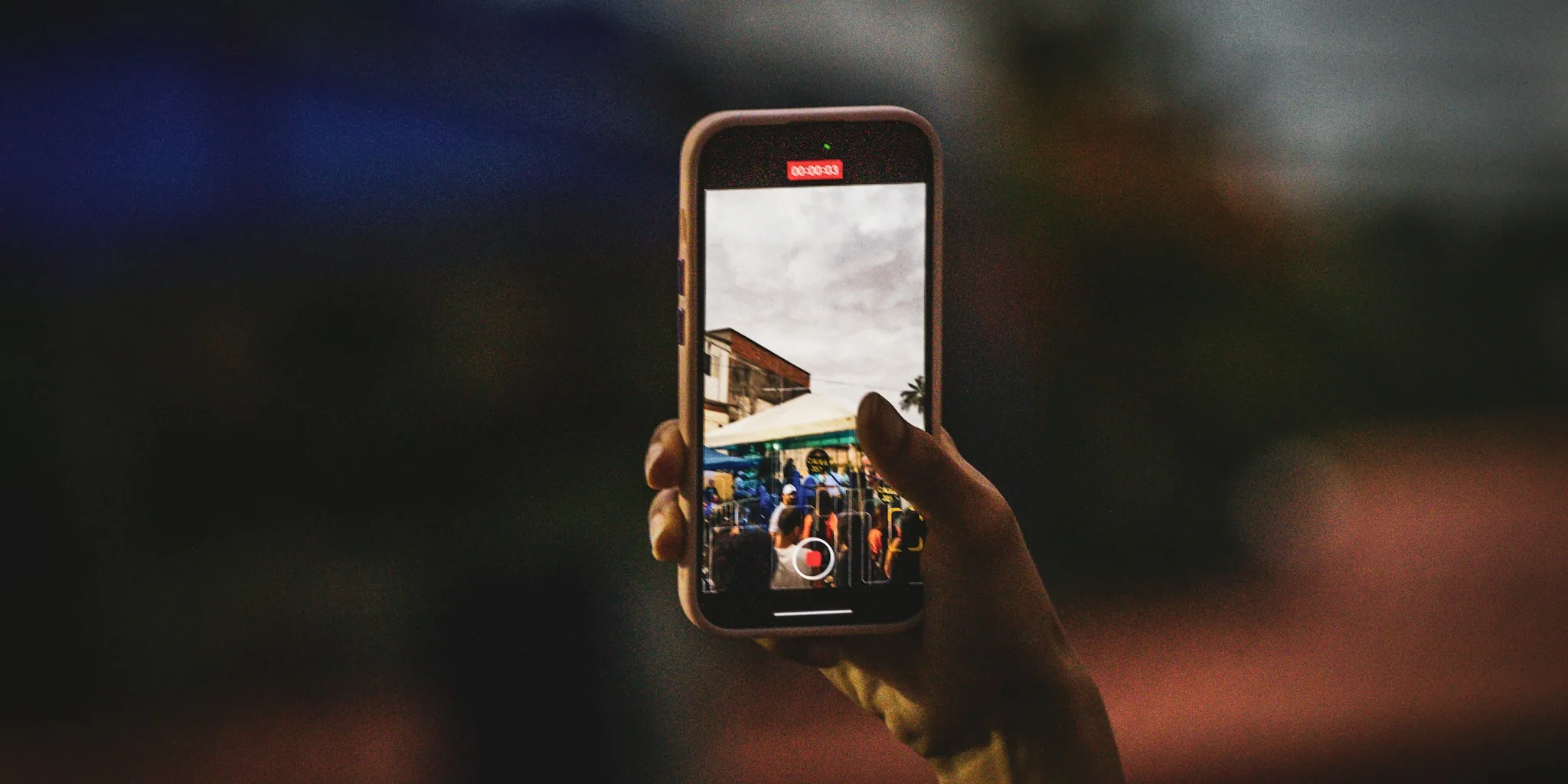 Person using smartphone for photography and mobile apps in natural daylight
