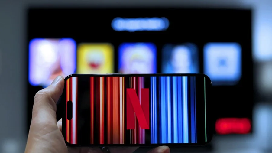 7 Tips for Watching Free TV and Movies on Your TV from Anywhere 2 person using smartphone to stream content