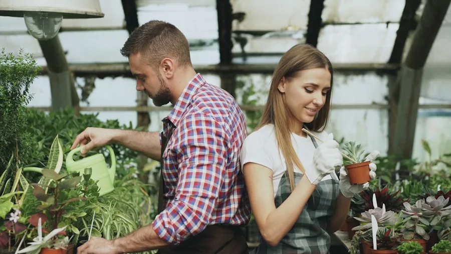 Person watering garden plants with hose nozzle in backyard setting
