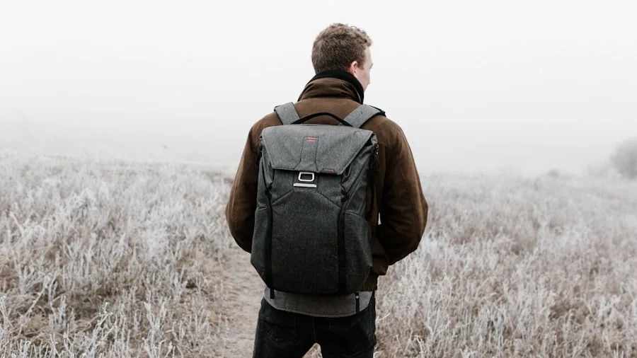 The %product_count% Best Travel Backpacks 3 Person wearing backpack in rain, water droplets on fabric during outdoor travel