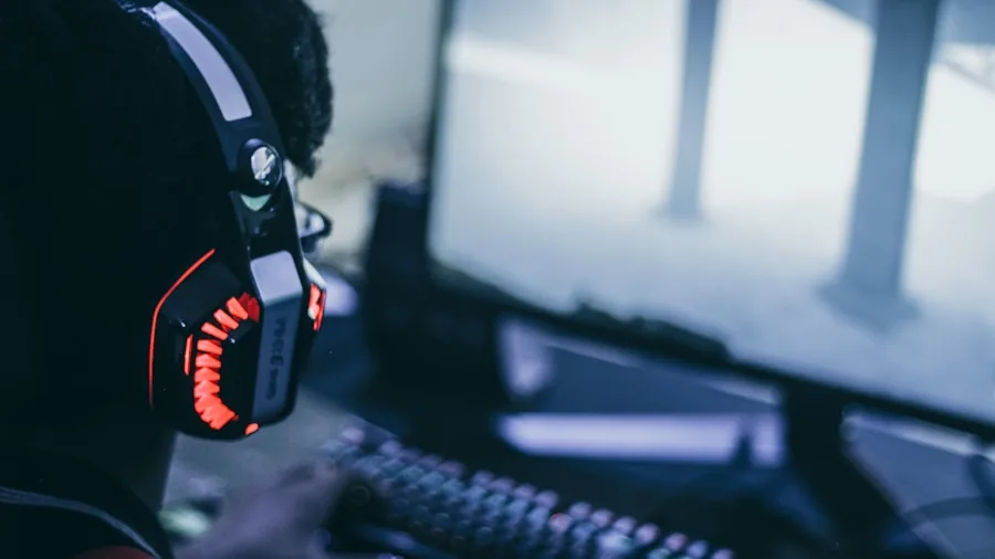 Person wearing comfortable headphones during extended gaming session at desk