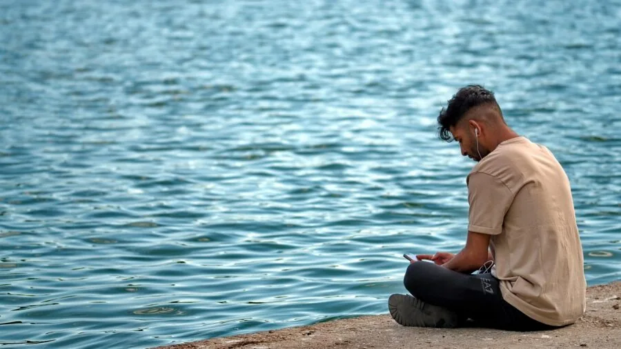Person wearing comfortable headphones while relaxing, demonstrating proper fit and extended wear comfort