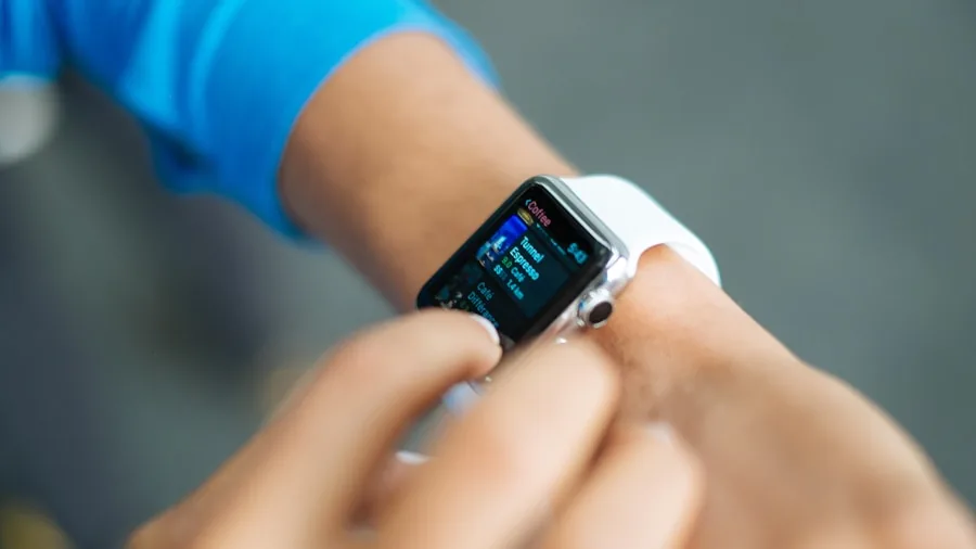 The %product_count% Best Fitness Trackers 5 Person wearing fitness tracker on wrist while exercising outdoors in natural daylight