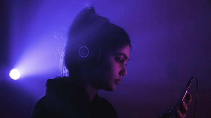 Person wearing headphones enjoying music with eyes closed in a relaxed setting