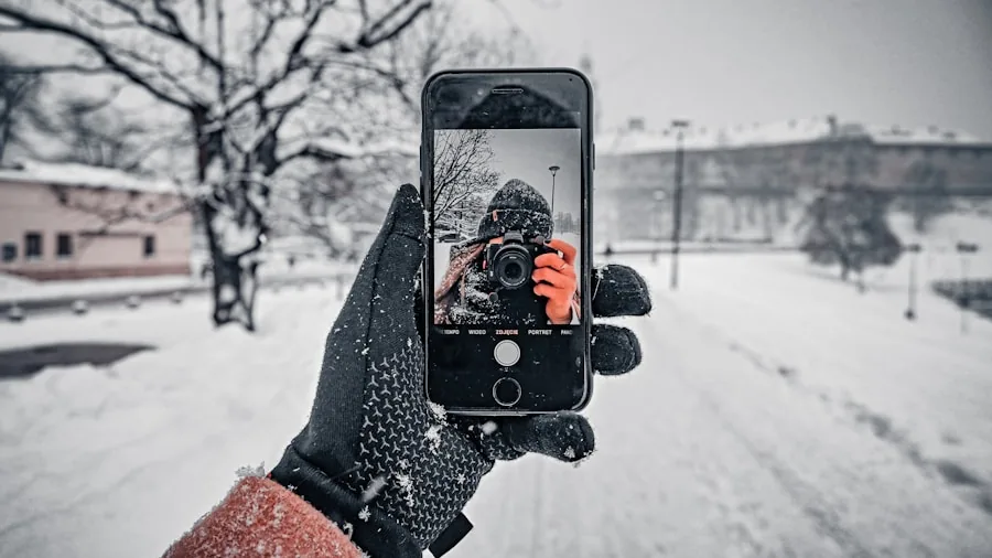 The %product_count% Best Ski Gloves 6 Person wearing winter gloves operating smartphone in snowy outdoor setting