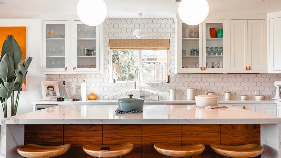 Person wiping down a contemporary kitchen countertop with undermount sink during daily cleaning routine