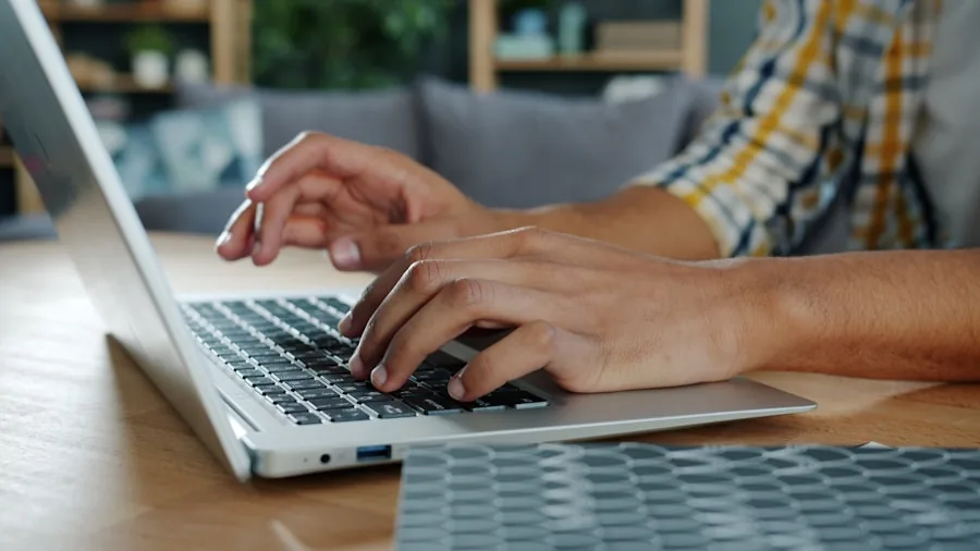 The %product_count% Best Keyboards 4 Person working at desk with proper ergonomic posture and wrist position while typing