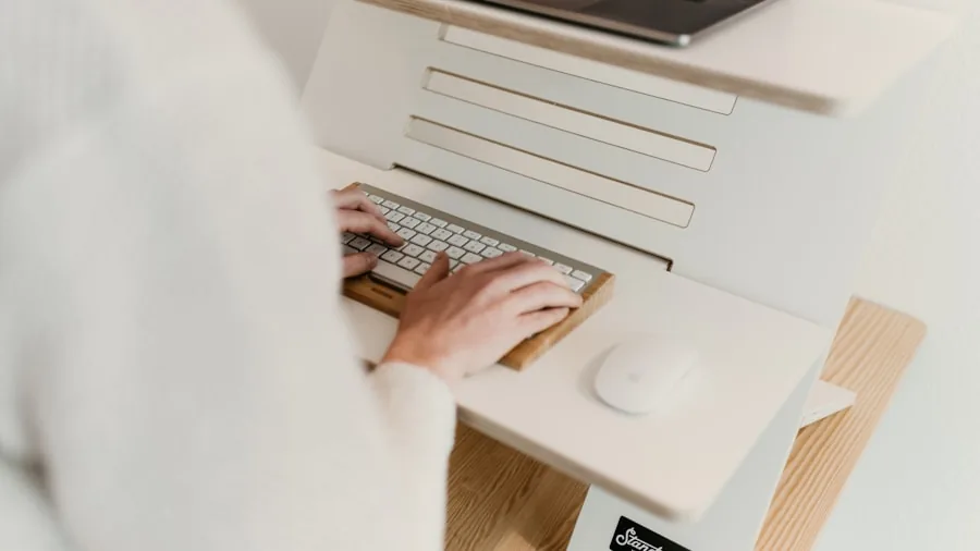 Person working at desk with proper hand posture and ergonomic setup for comfortable typing