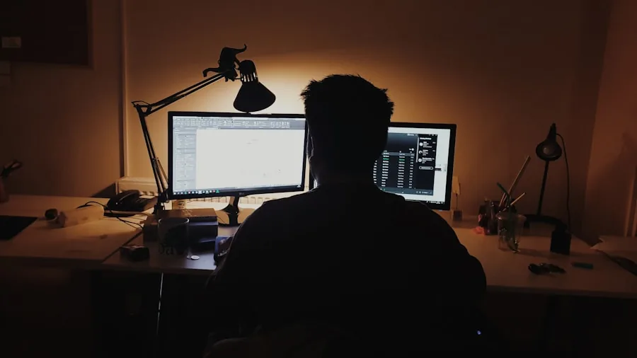 Person working at desk with warm lamp lighting during evening study session