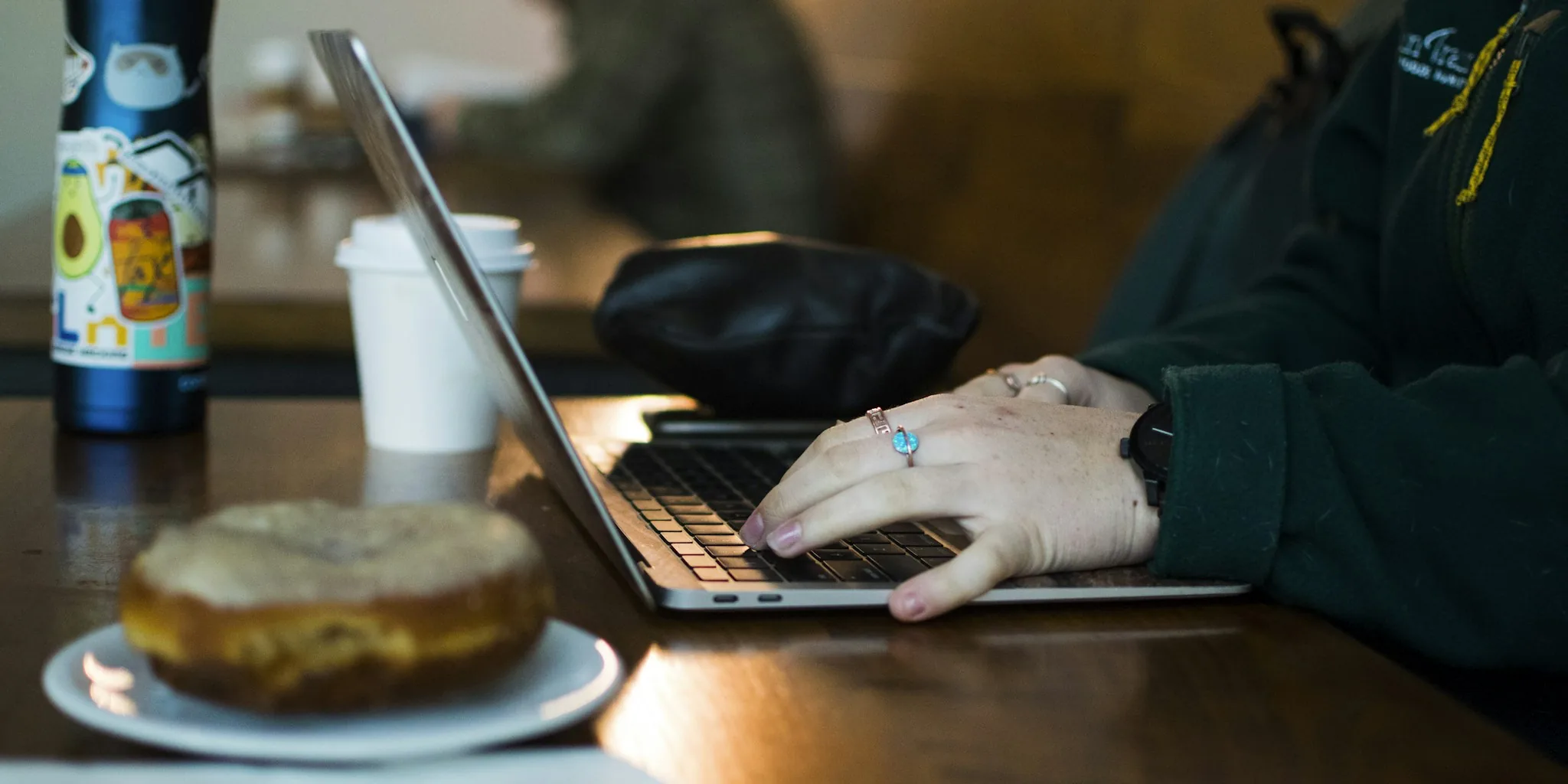 person working on laptop in cafe