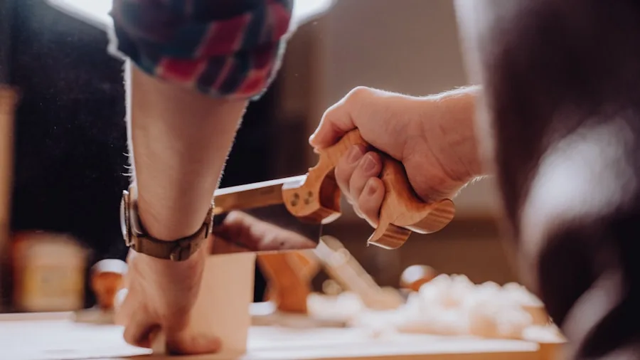 Person working on wooden craft project with various tools and accessories in home workshop